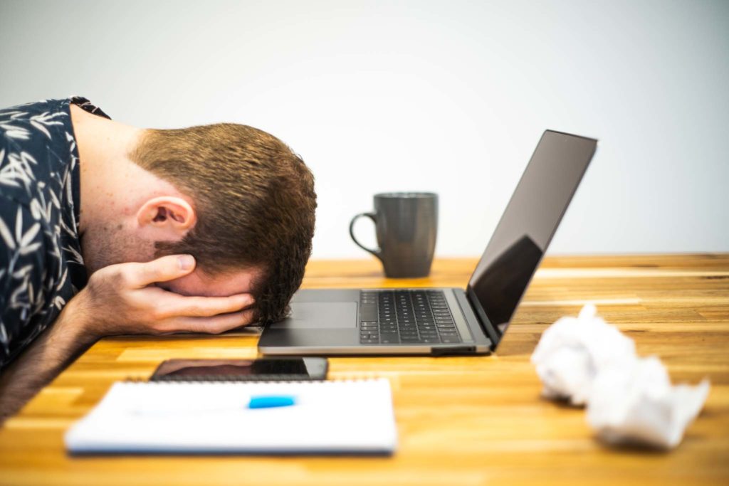 A journalist lying his head down at his computer, upset. 

Image credit: https://www.microbizmag.co.uk