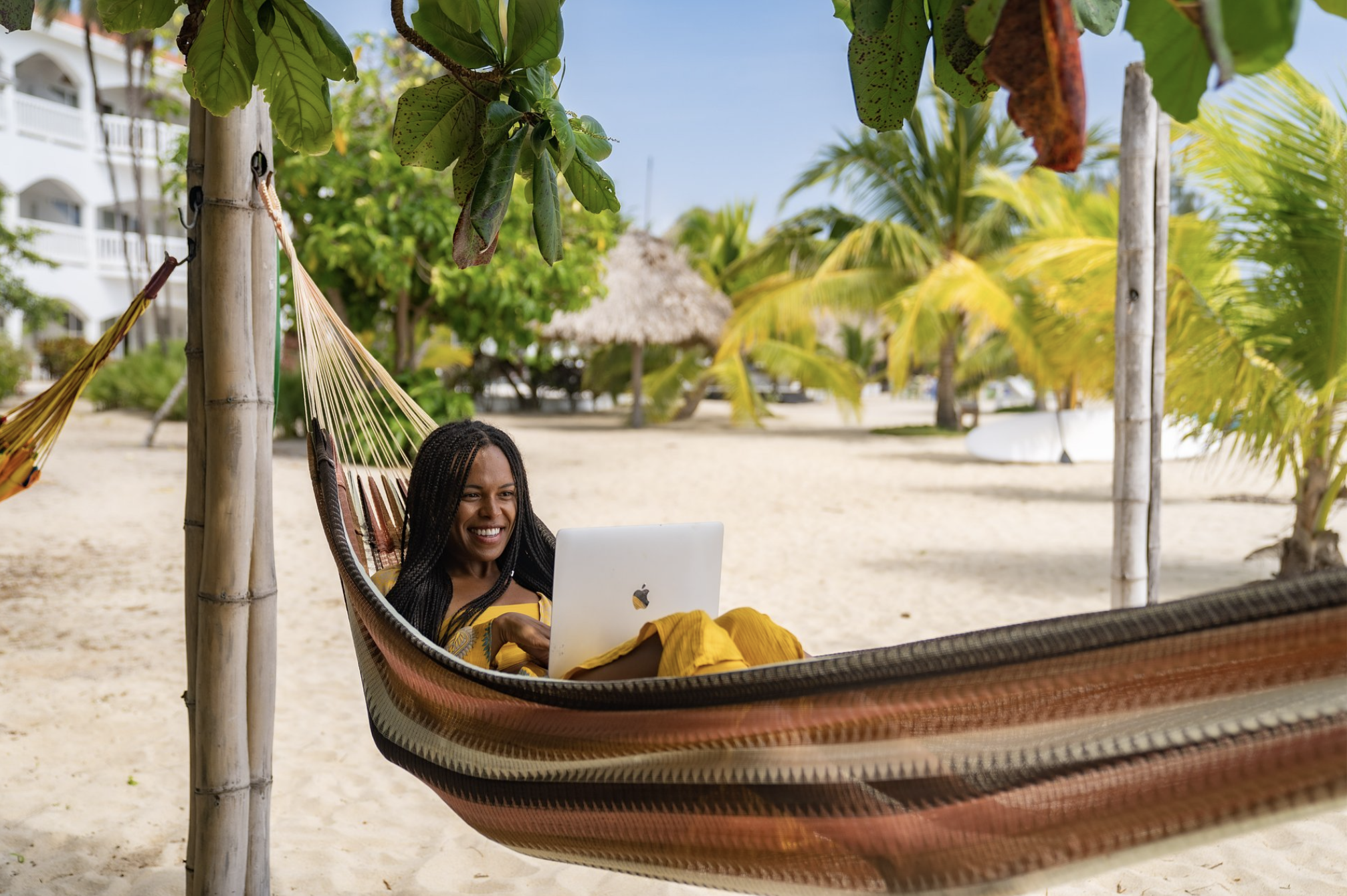 Woman on laptop in hammock