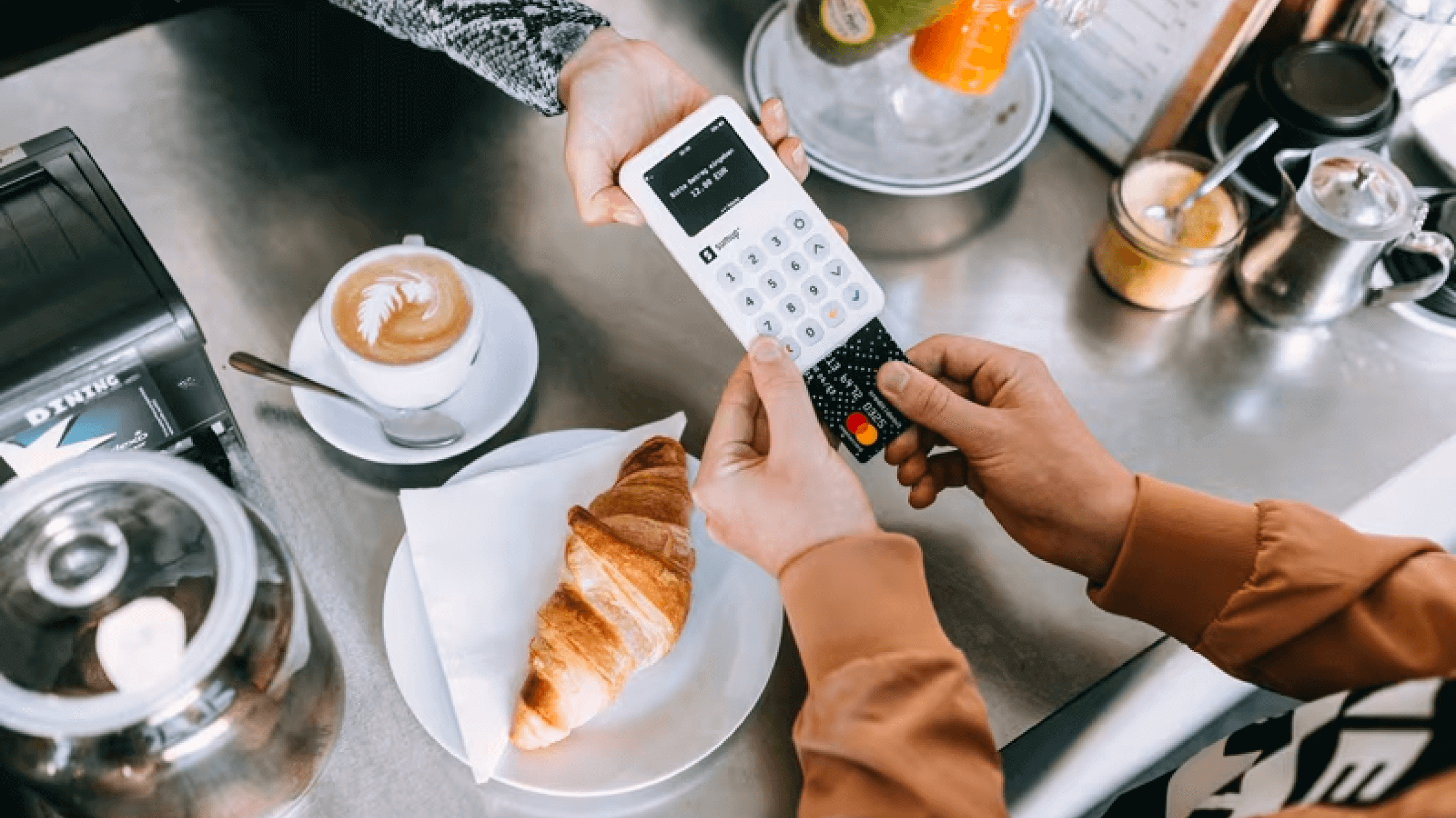 A customer pays at a coffee shop.