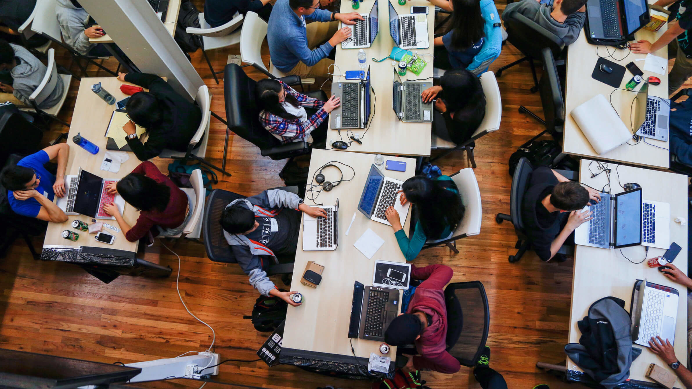 Overhead shot of workers on their laptops in an office