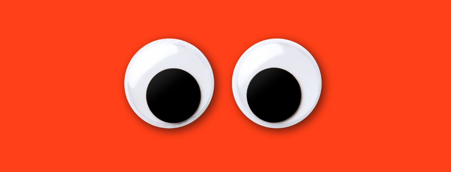 Googly eyes on a red background.