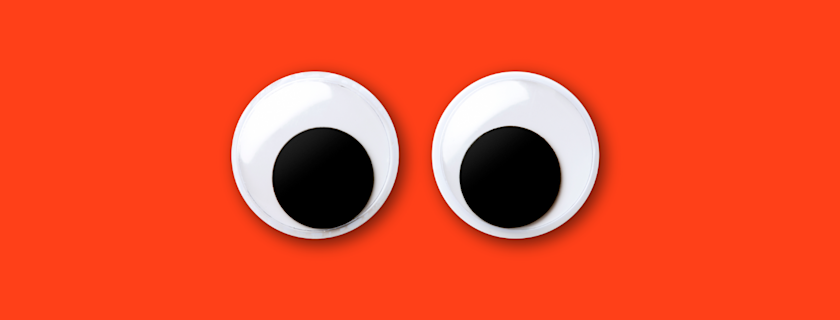 Googly eyes on a red background.