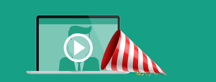 A laptop with a play button icon on the screen, next to a party hat with red and white stripes.
