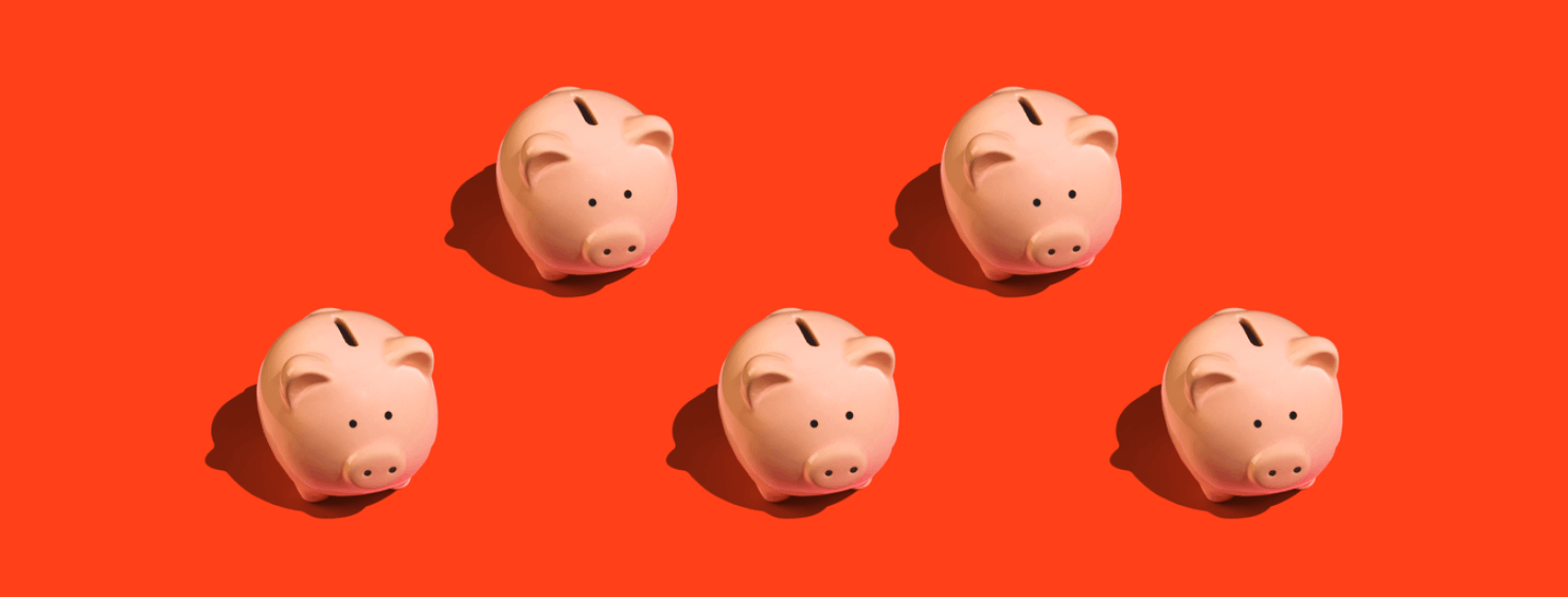 Five pink piggy banks arranged in a row on a bright orange background.