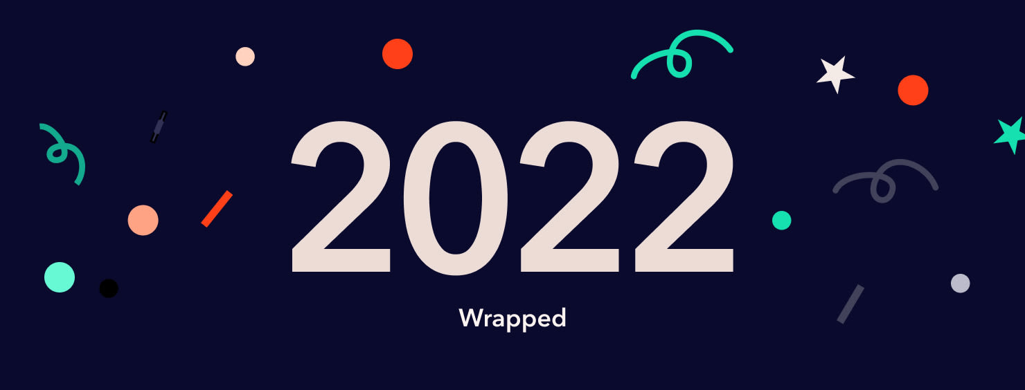 2022 Wrapped graphic with confetti and stars on a dark blue background.