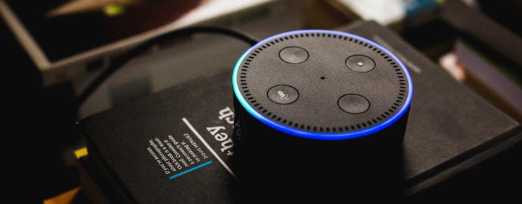 Amazon Echo Dot sitting on top of a book.