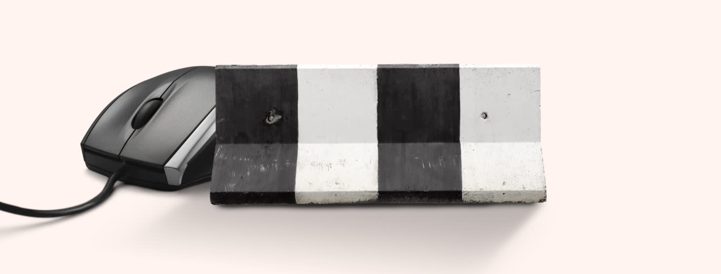 A computer mouse partially obscured by a black and white striped concrete barrier, symbolic of online censorship.
