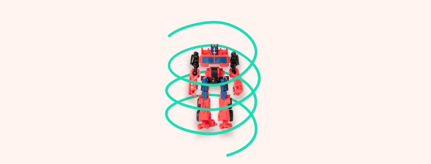 A red and blue transformer toy stands with a green swirling line around it on a light peach background.