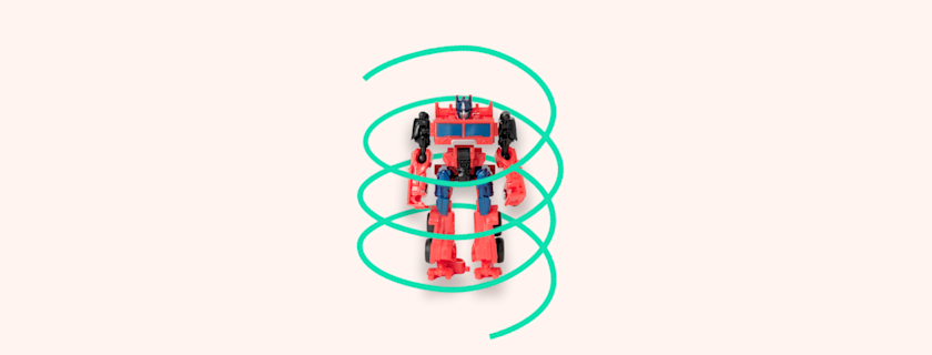 A red and blue transformer toy stands with a green swirling line around it on a light peach background.