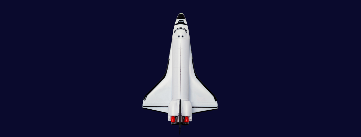 A top-down view of a white space shuttle against a dark blue background.