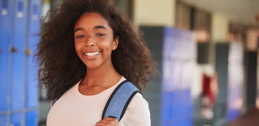 Smiling teenage girl at school