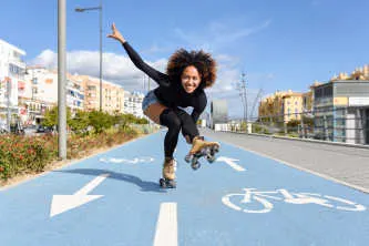 Black woman on roller skates riding outdoors