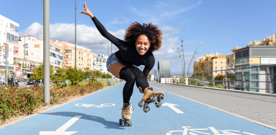 Black woman on roller skates riding outdoors