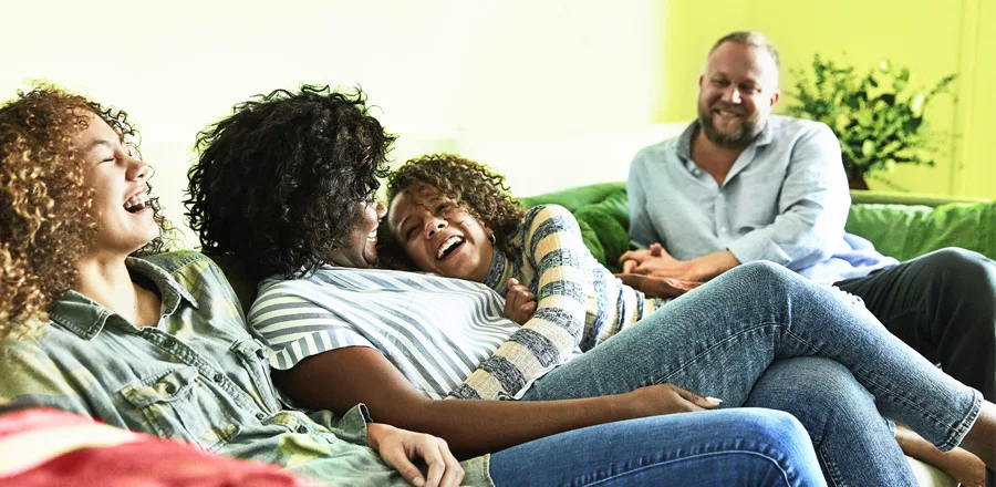 Laughing family sitting on the sofa