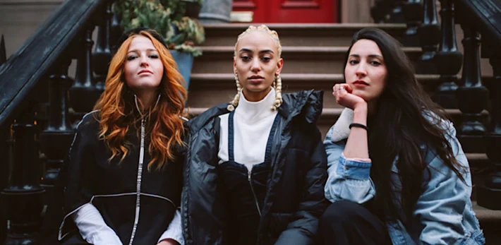 Three young women sitting on the stairs