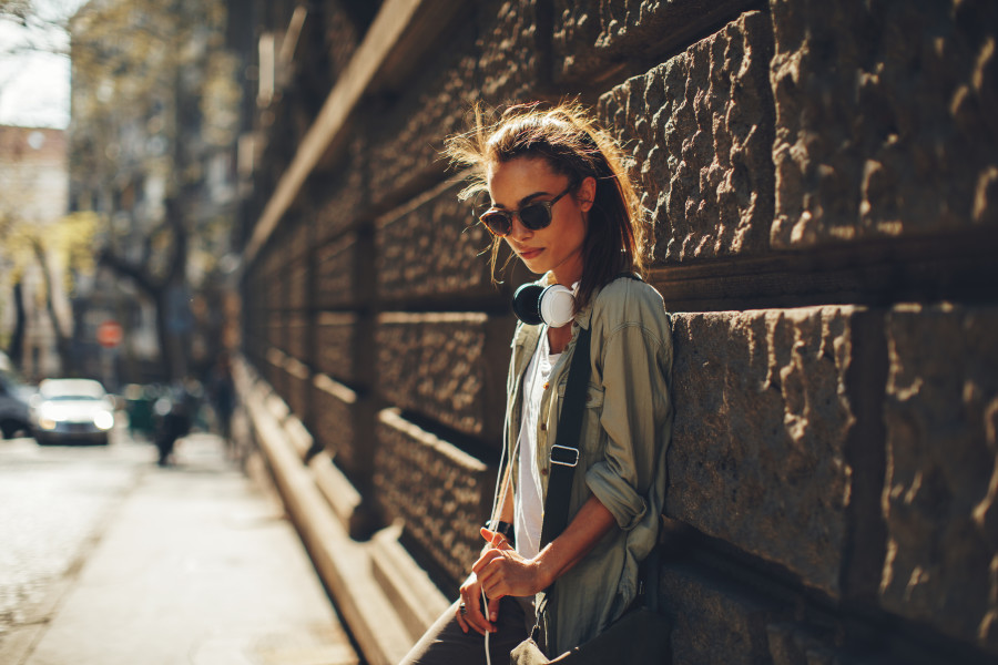 Teenage girl leaning against a wall