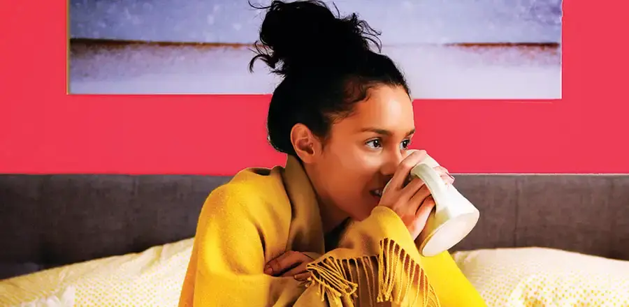 Young woman with cup of tea in her hands