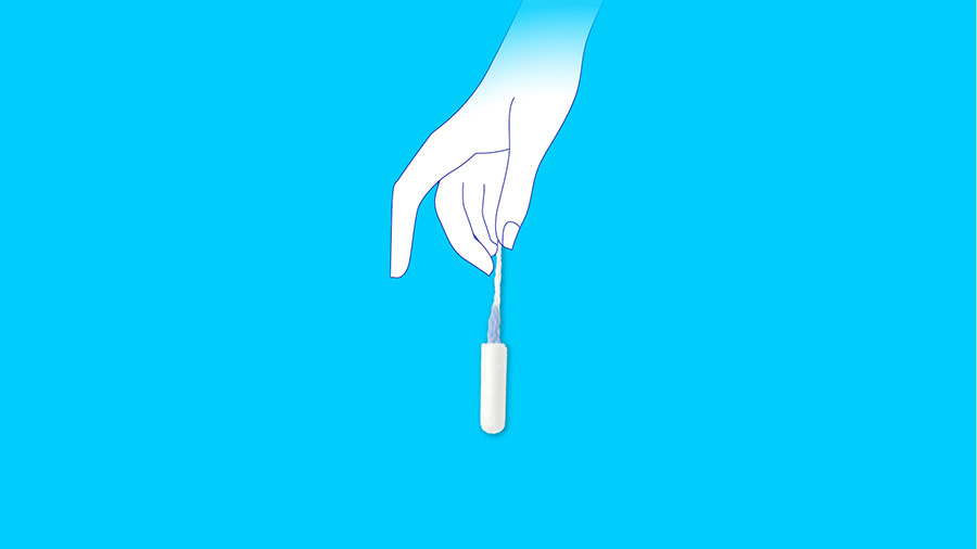 Female hand holding a clean tampon