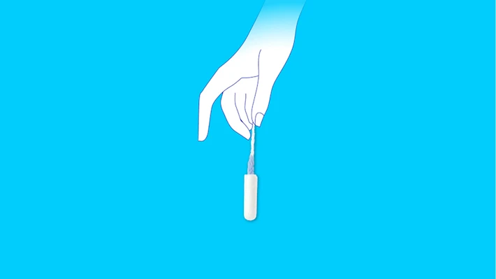Female hand holding a clean tampon