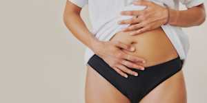 Image of a person touching their stomach