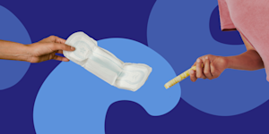 One hand holding a pad and one hand holding a tampon on dark purple background