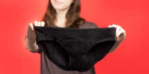 Photo of woman holding up a pair of Rael period panties