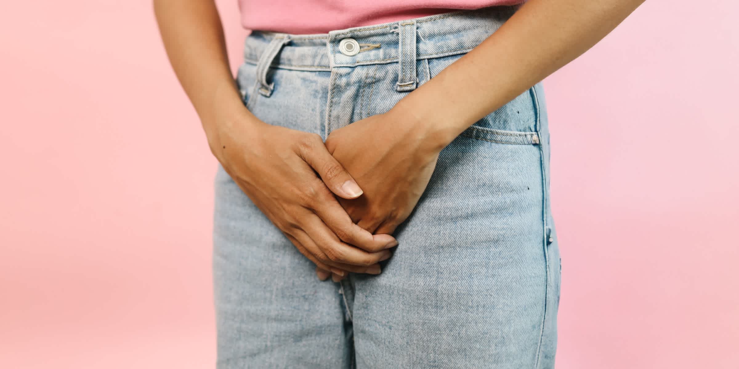 Person holding their hands over their jeans