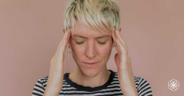 photo of a stressed women holding her head