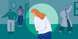 Image of a woman holding her abdomen in a doctor's office.