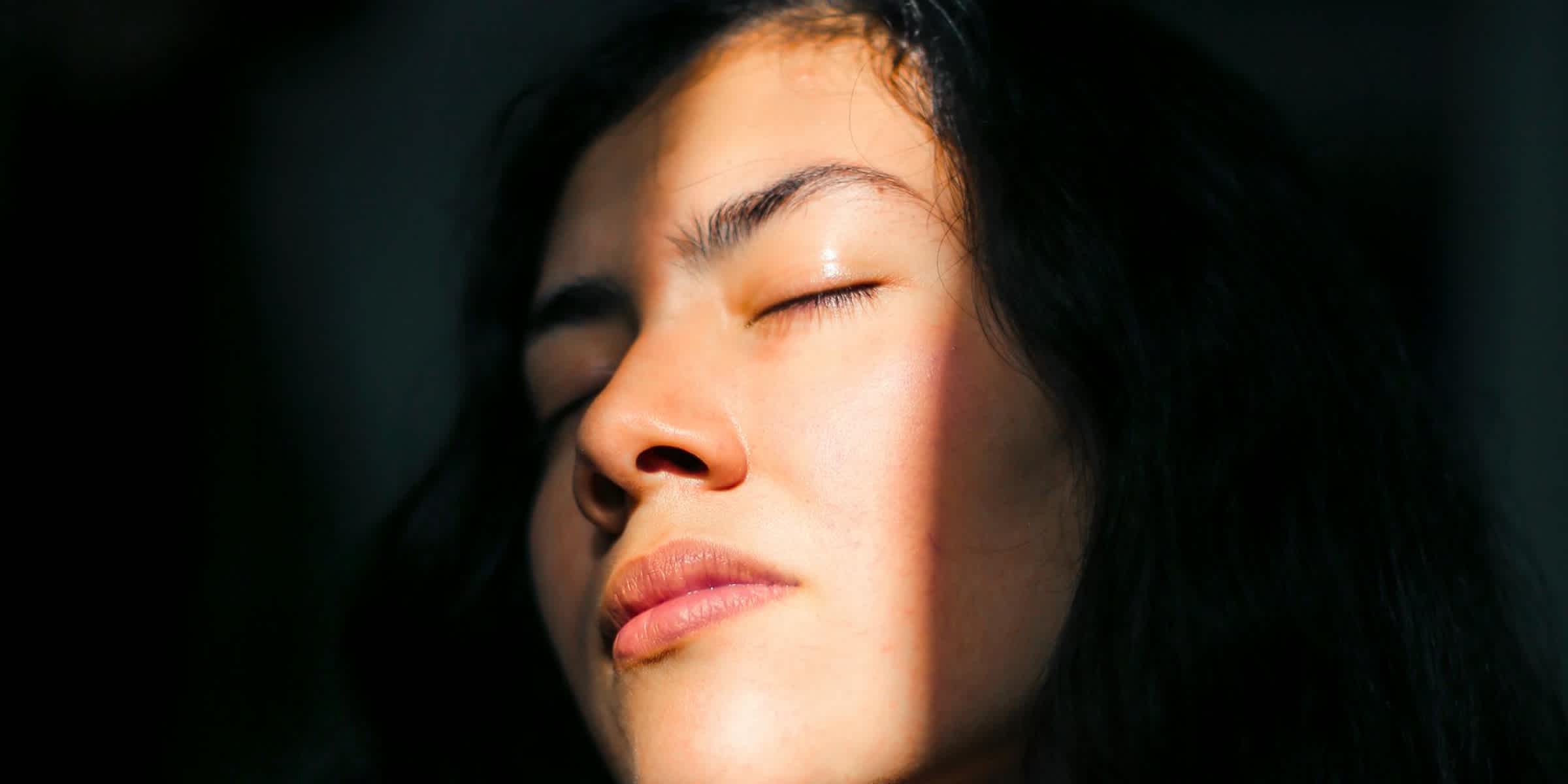 person with their face half in shadows with some sunlight