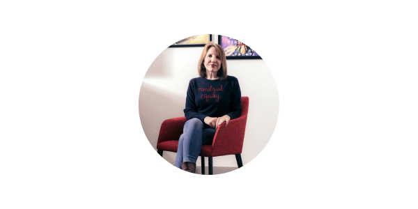 Photo of Jennifer Weiss Wolf, sitting on an armchair