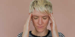 photo of a stressed woman holding her head