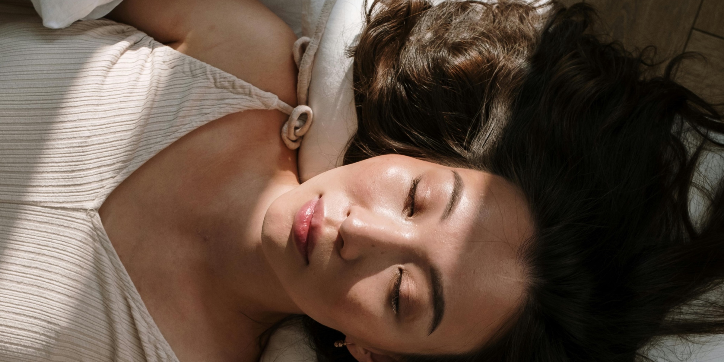 woman laying down with sunlight on her face