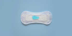 Photo of a pad from the top with blue liquid on it, on a blue background