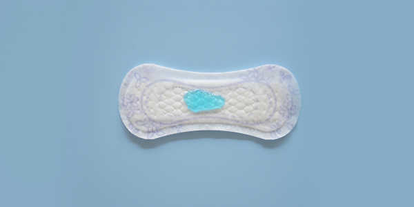 Photo of a pad from the top with blue liquid on it, on a blue background