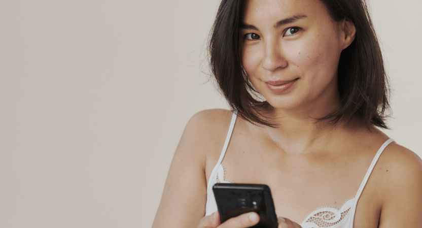 An image of a woman holding a smartphone