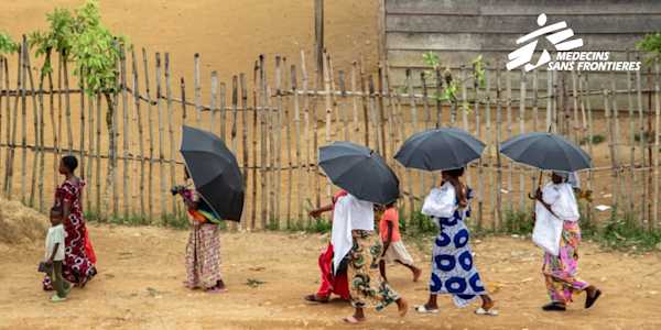 image of women in the DRC walking and with the MSF logo in the top right corner