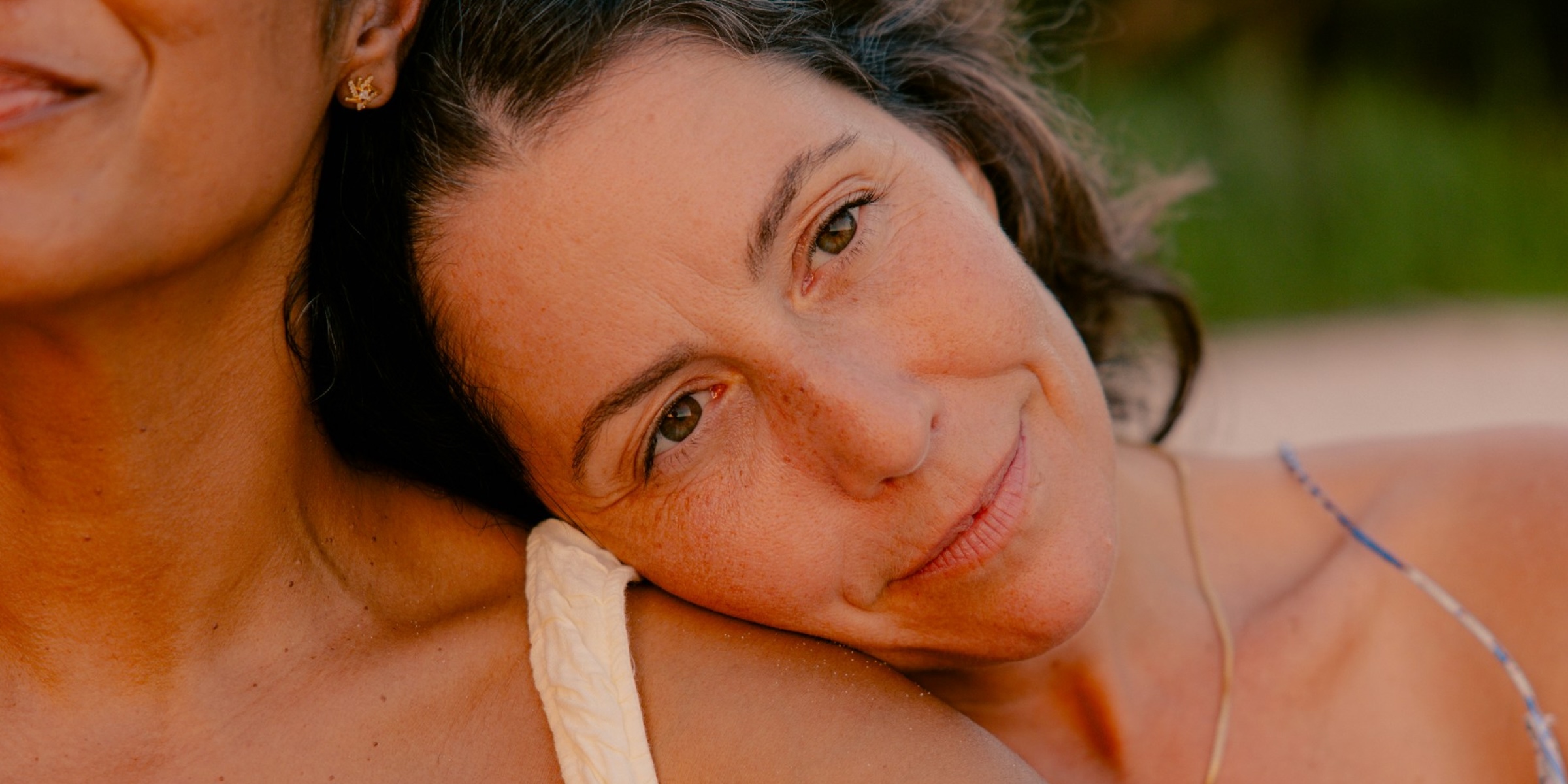 two women with one woman resting her head on the other