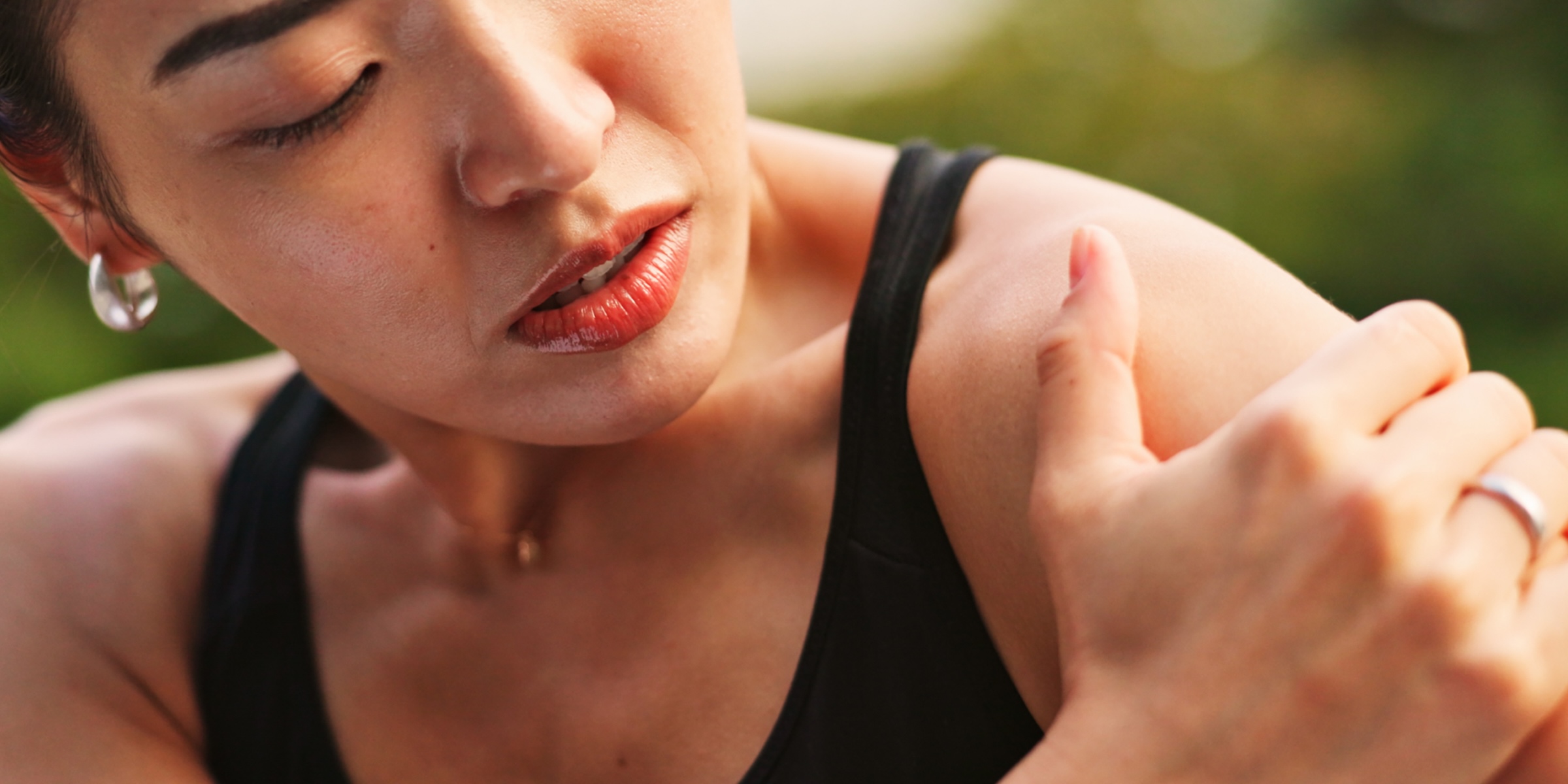 Woman grasping her shoulder joint in pain