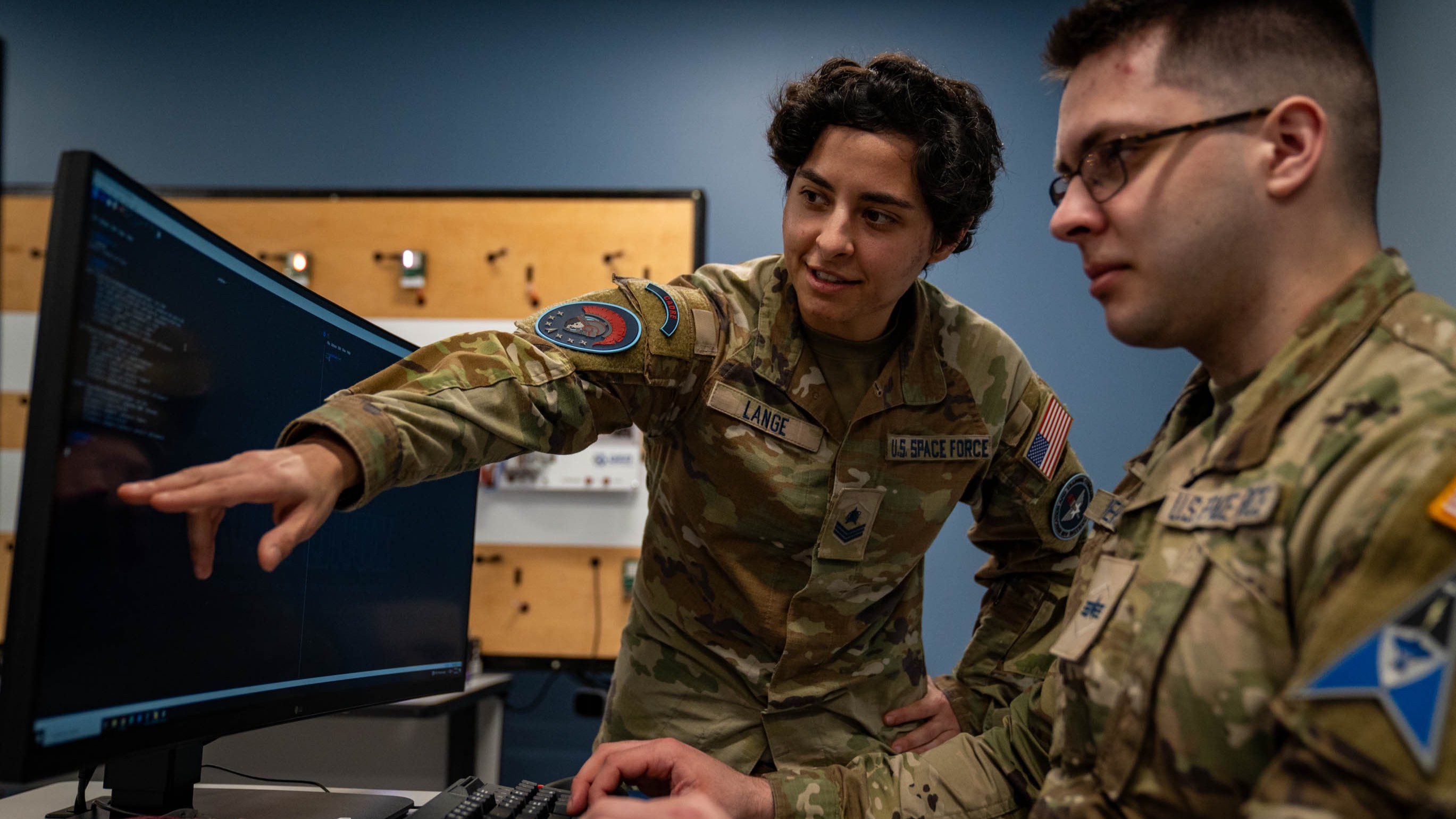 U.S. Space Force Sgt. Anastacia Lange, 333rd Training Squadron Cyber Warfare Operator course instructor, teaches Tech Sgt. Ryan Simons, 333rd TRS student, how to run commands in Linux Operating Systems at Stennis Hall on Keesler Air Force Base, Mississippi, Jan. 24, 2024. Lange made history as the first Guardian and the first female to teach the CWO course. (U.S. Air Force photo by Senior Airman Elizabeth Davis)