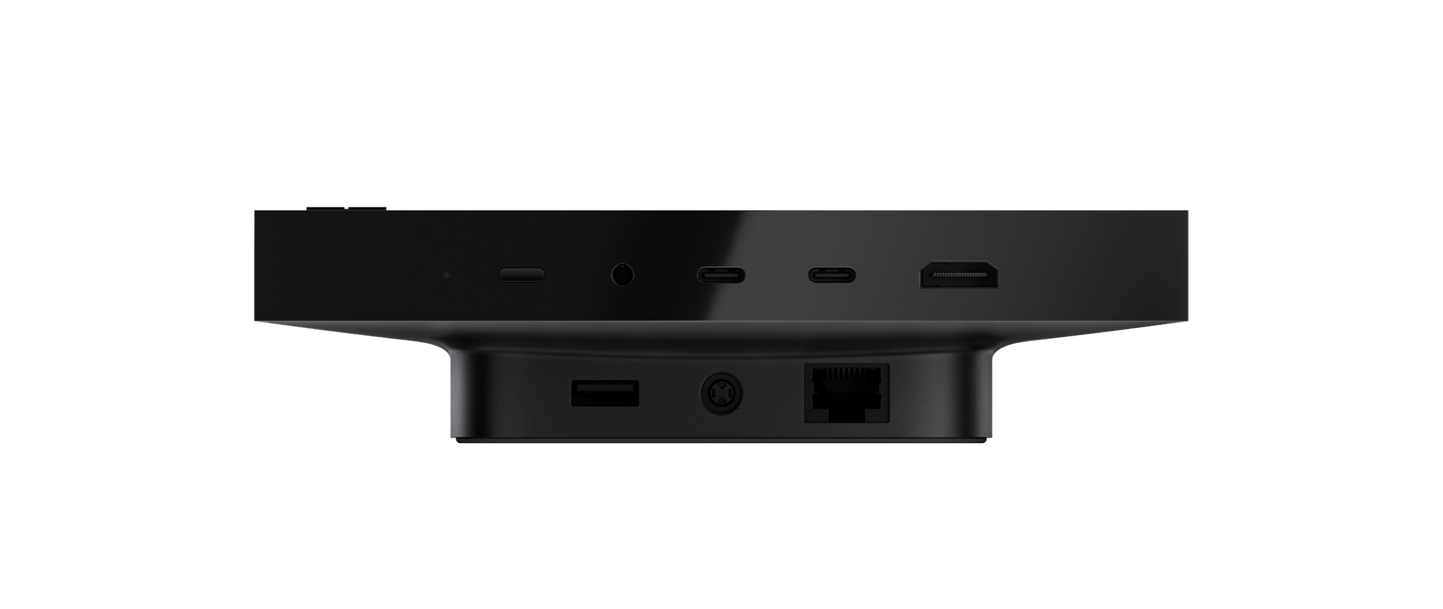 Side view of black hardware device showing multiple ports including USB‑C, headphone jack, and Ethernet connection on a raised base
