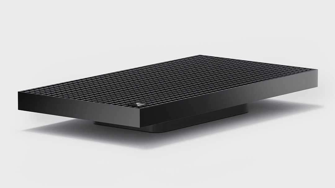 Black rectangular device with a grid-pattern top on a light background