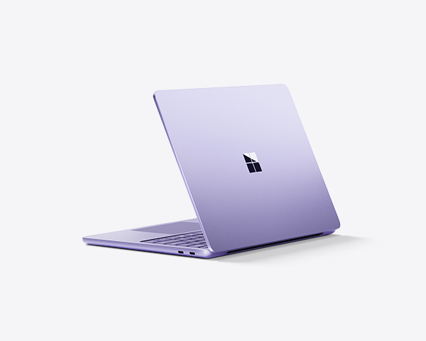 Violet Surface laptop partially open on a light background