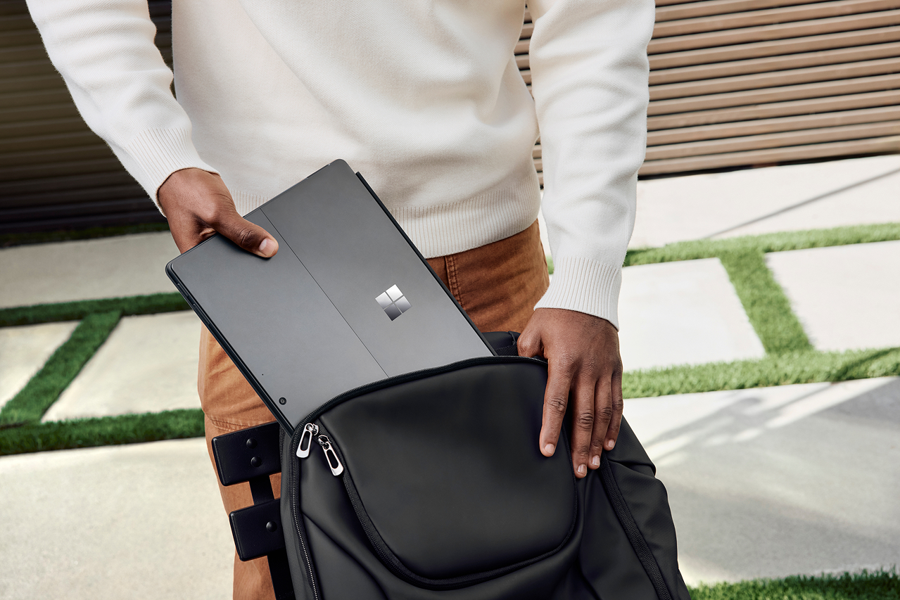 Person pulling Surface Pro out of their computer bag.