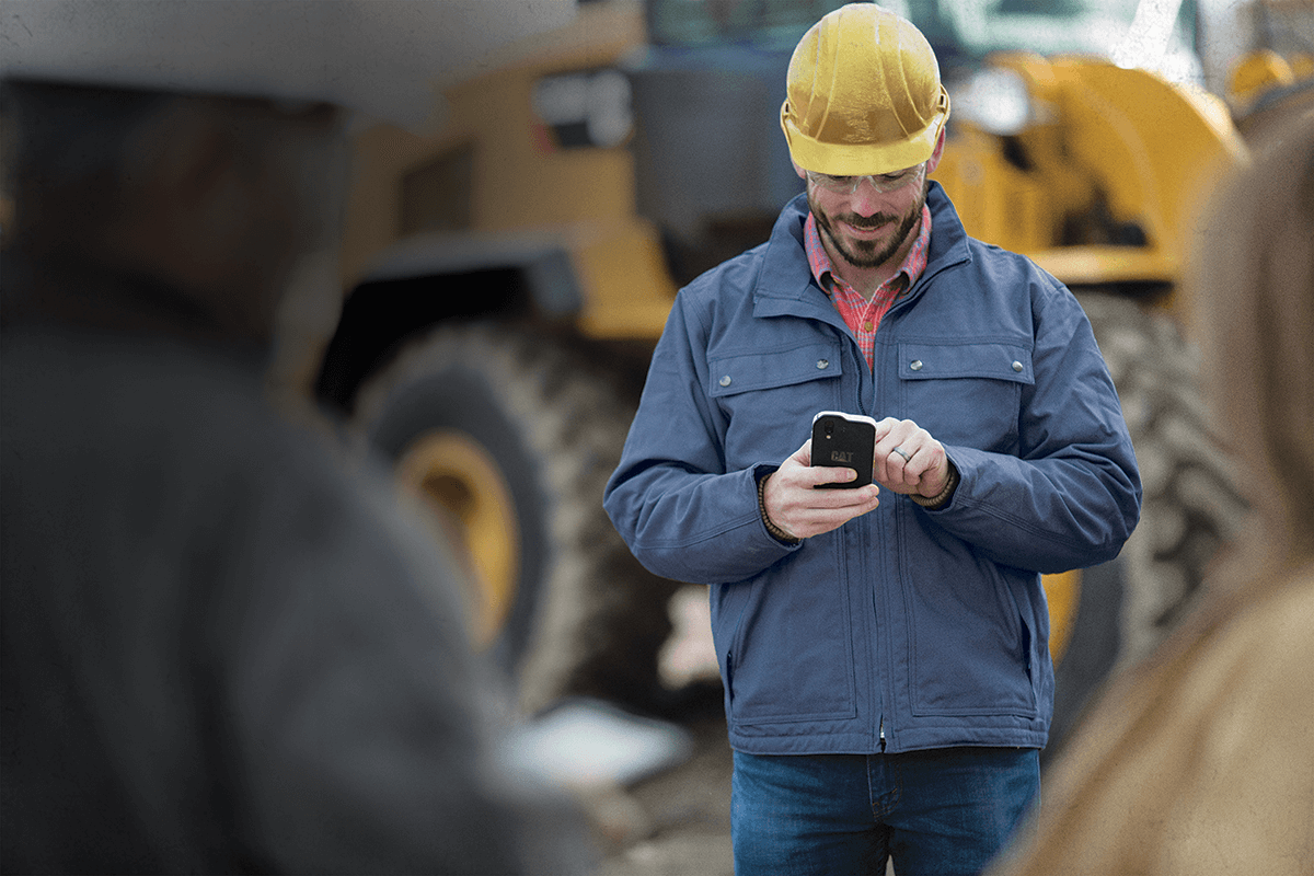Man using smartphone in the field