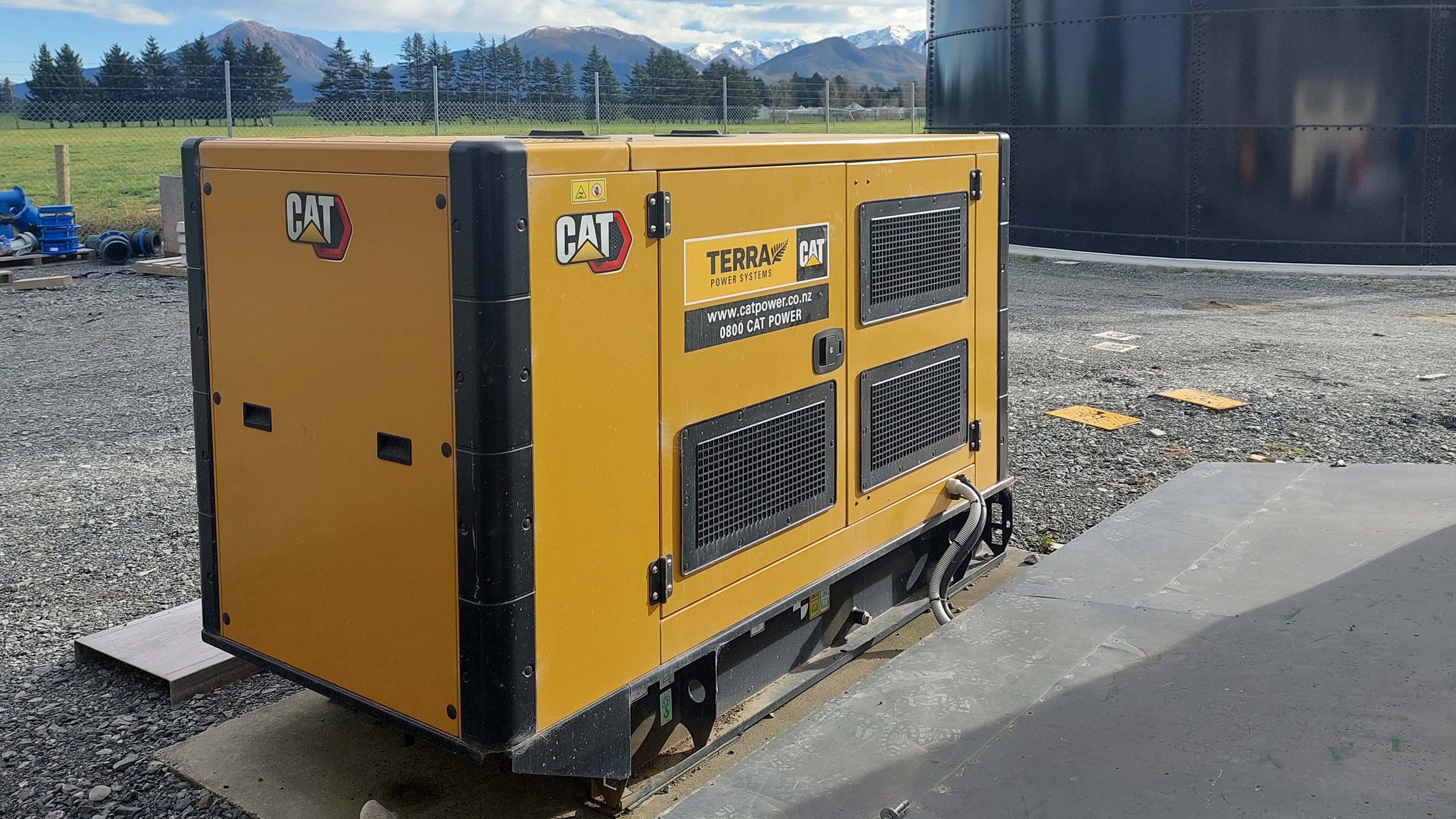 Terra Cat Power Generator Set in front of water tank