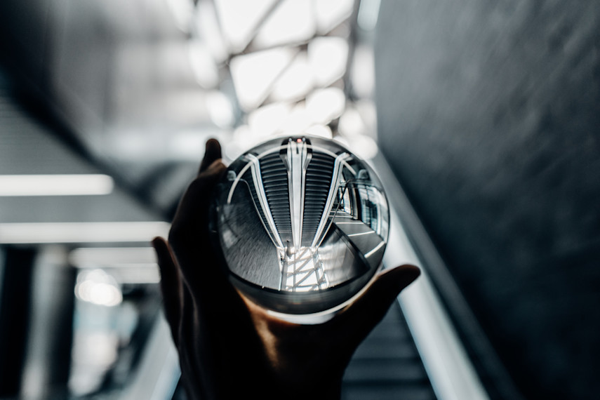 Image of a crystal ball being held up by a hand