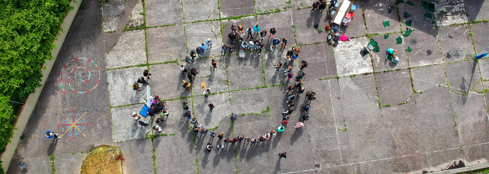 Image of aerial view of people standing in a circle