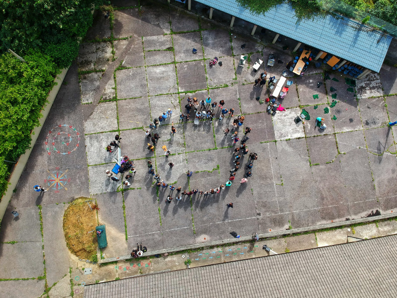 Image of aerial view of people standing in a circle