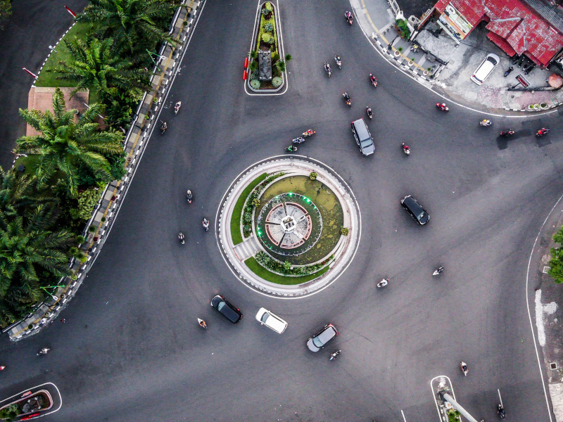 Image of aerial view of a roundabout with cars driving around it